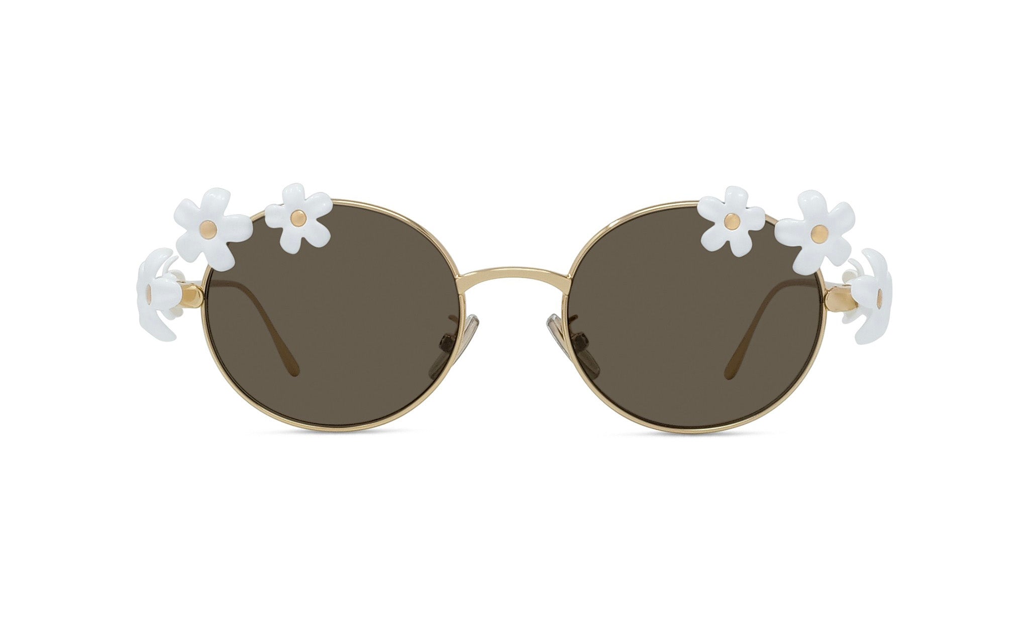 A pair of round sunglasses with dark lenses and white flower embellishments on the sides.