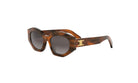 A pair of brown, tortoiseshell-framed sunglasses with a gold C logo on the side.