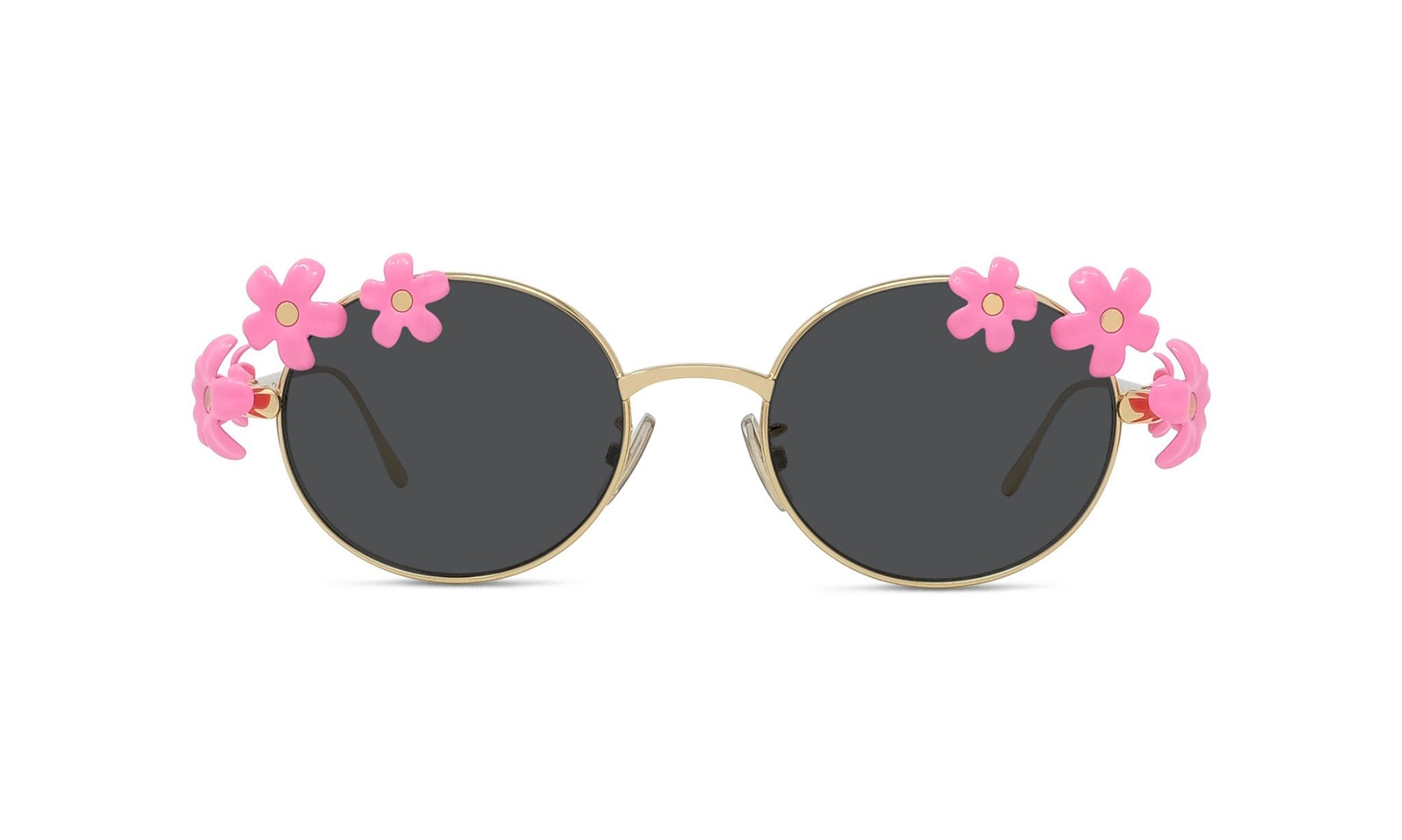 A pair of round sunglasses with black lenses and gold frames, adorned with pink flower decorations on the sides.