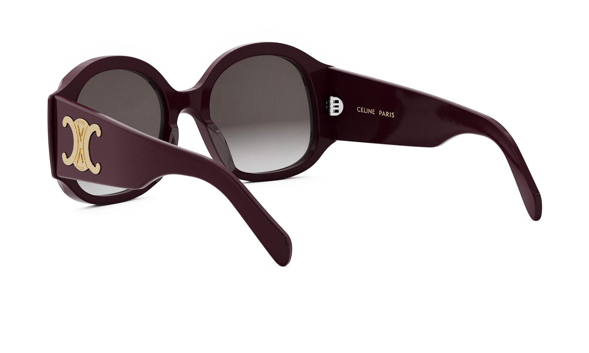 A pair of burgundy-colored sunglasses with a gold logo on the frame.