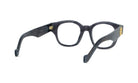 A pair of dark-colored, framed glasses with a gold-colored accent on the temples.