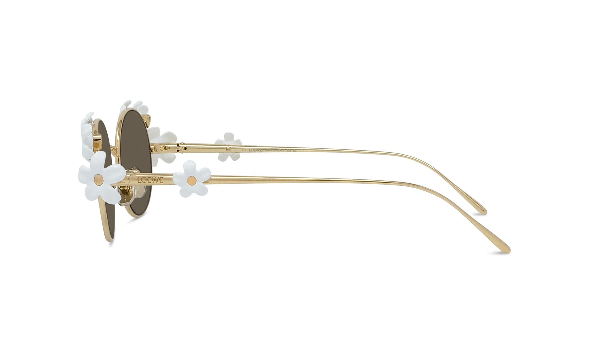 A pair of gold-colored sunglasses with white flower-shaped embellishments on the temples and arms.