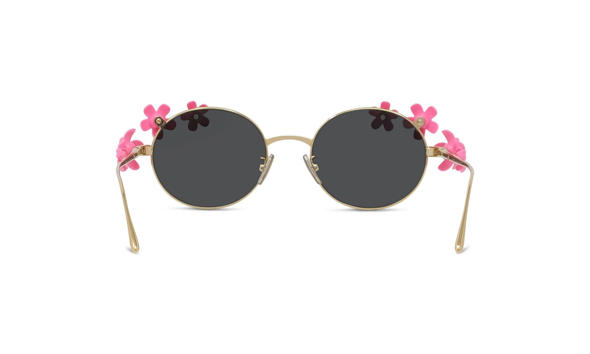 A pair of round sunglasses with black lenses and gold frames, adorned with pink flower decorations on the sides.