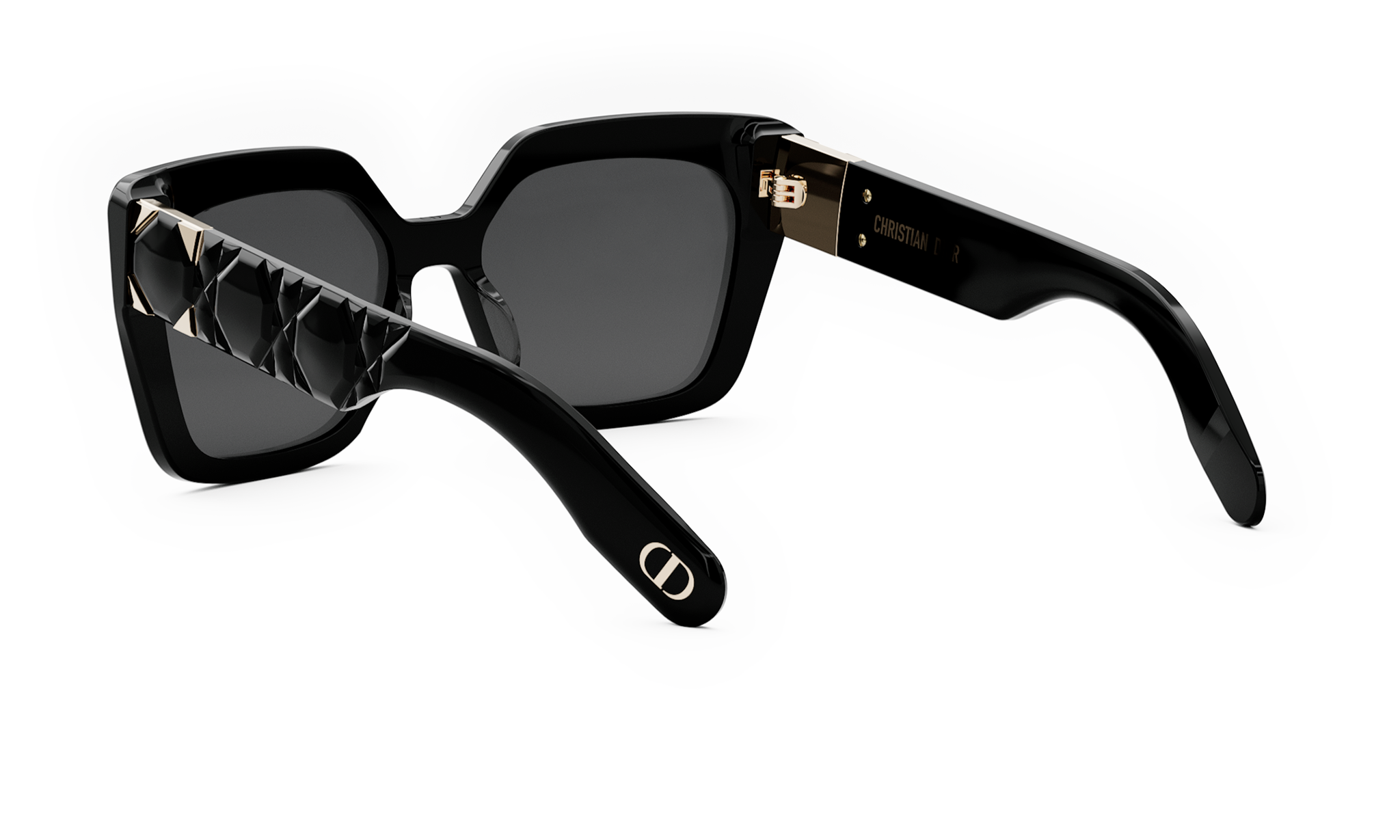 A pair of black sunglasses with a gold-colored frame and a diamond pattern on the arm rest.