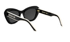 A pair of black cat-eye sunglasses with white accents, featuring the brand name "CHRISTIAN DOR" on the frame.