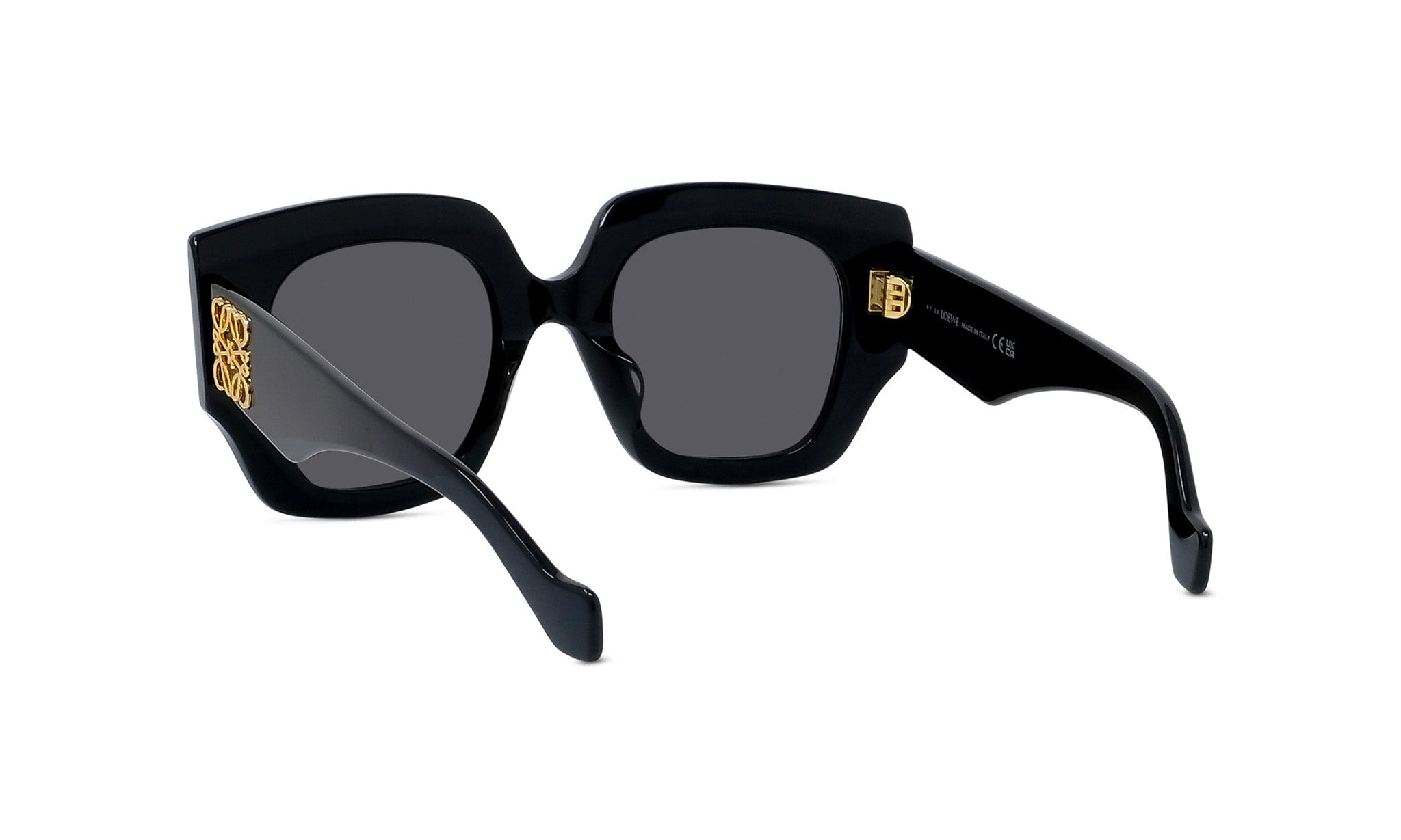 A pair of black sunglasses with gold accents, featuring a square frame and dark lenses.