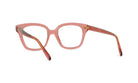 A pair of pink-framed glasses with a brown frame, positioned facing away from the camera.
