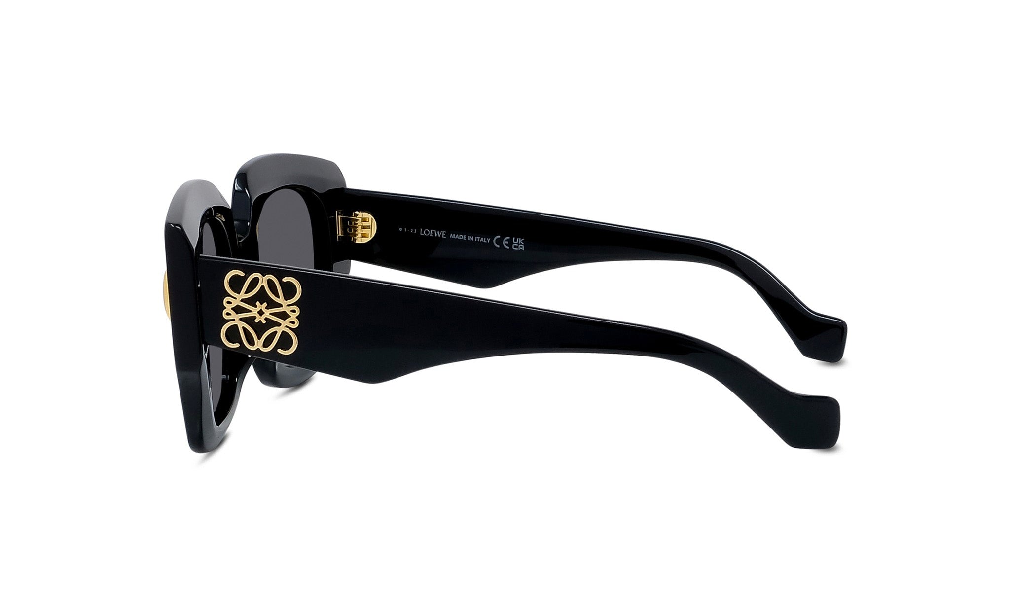 A pair of black sunglasses with gold accents, featuring a unique logo design on the frame.