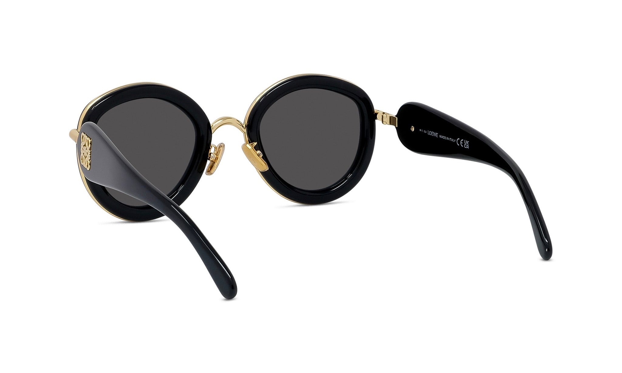 A pair of black sunglasses with gold accents, featuring a round frame and dark lenses.