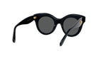 A pair of black cat-eye sunglasses with dark lenses and a gold-colored frame.