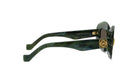 A pair of green-framed sunglasses with a gold-colored logo on the temples.