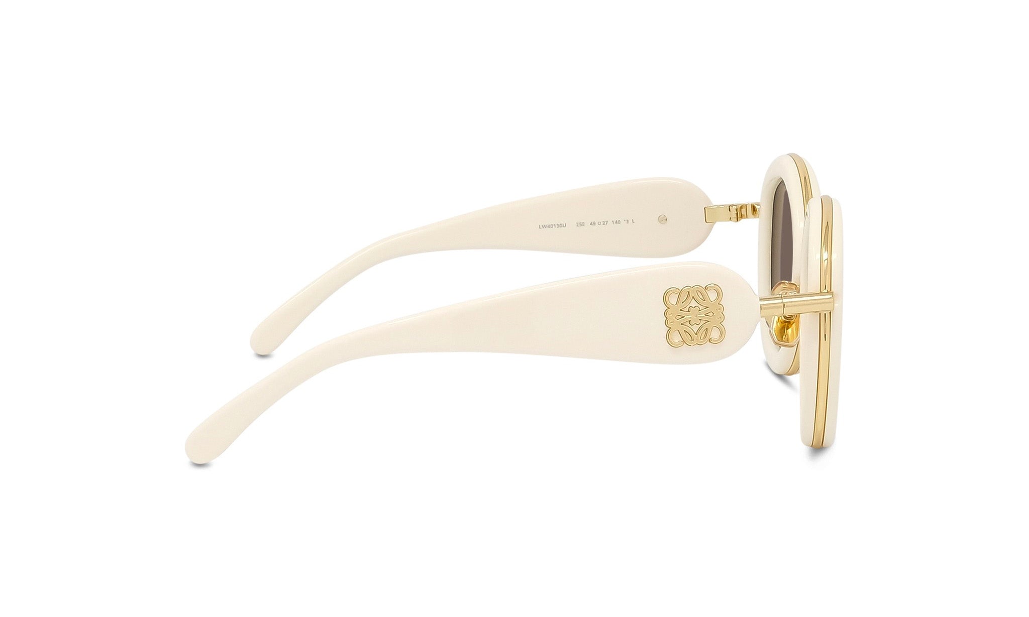 A pair of white, gold, and black sunglasses with a gold emblem on the frame.