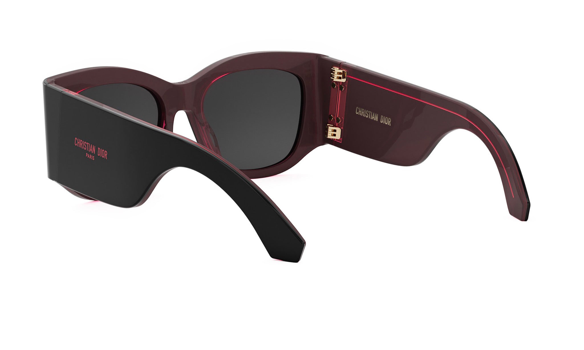 A pair of dark-colored sunglasses with a red accent, featuring the brand name "Christian Dior" on the frame.