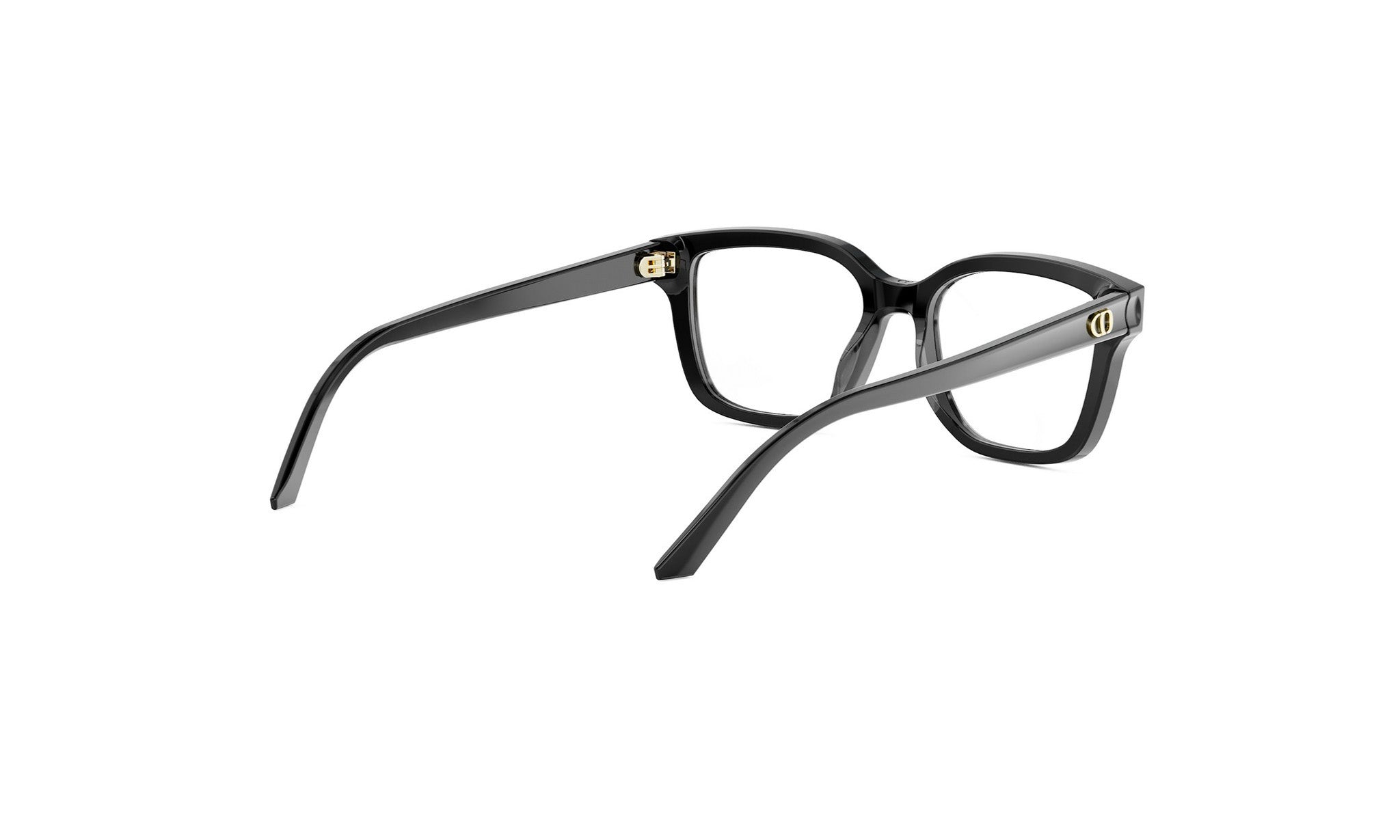 A pair of black-framed glasses with gold accents, positioned facing away from the camera.