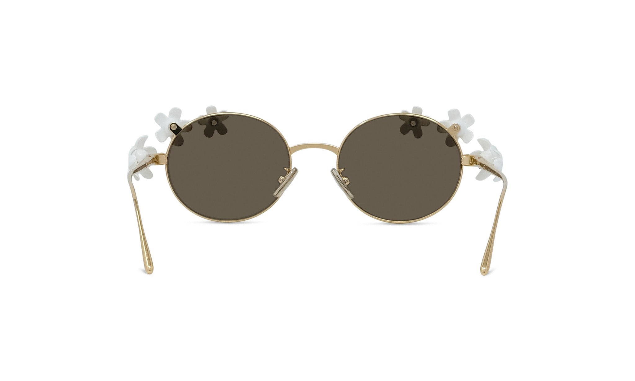 A pair of round, gold-colored sunglasses with dark lenses and white flower-shaped embellishments on the sides.
