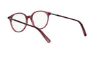 A pair of red-tinted eyeglasses with clear lenses, positioned facing the viewer.