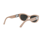 A pair of tan-colored sunglasses with black lenses, featuring a silver Dior logo on the temples.