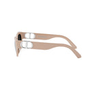 A pair of tan-colored sunglasses with a silver Dior logo on the frame.