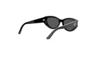 A pair of black cat-eye sunglasses with a gold-colored logo on the frame.