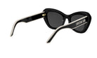 A pair of black sunglasses with a white frame and the brand name "Christian Dior" printed on the side.