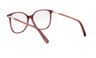 A pair of red-tinted glasses with gold-colored metal accents, resting on a white background.