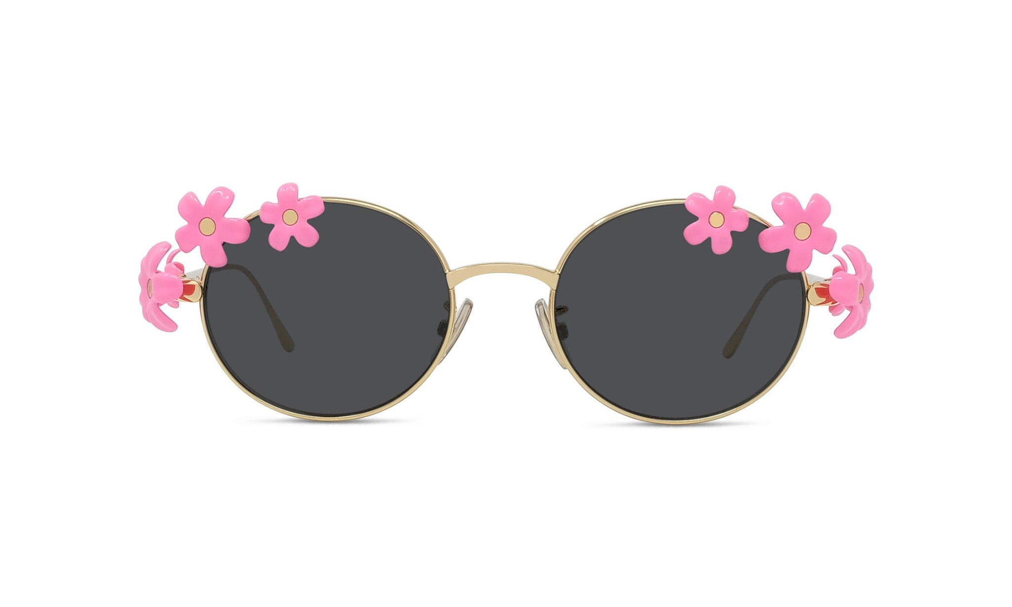 A pair of round sunglasses with black lenses and gold frames, adorned with pink flower decorations on the sides.