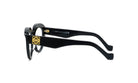 A pair of black-framed glasses with a gold-colored logo on the side.
