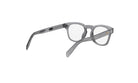 A pair of gray-framed glasses with clear lenses, positioned in a way that they are facing away from the camera.