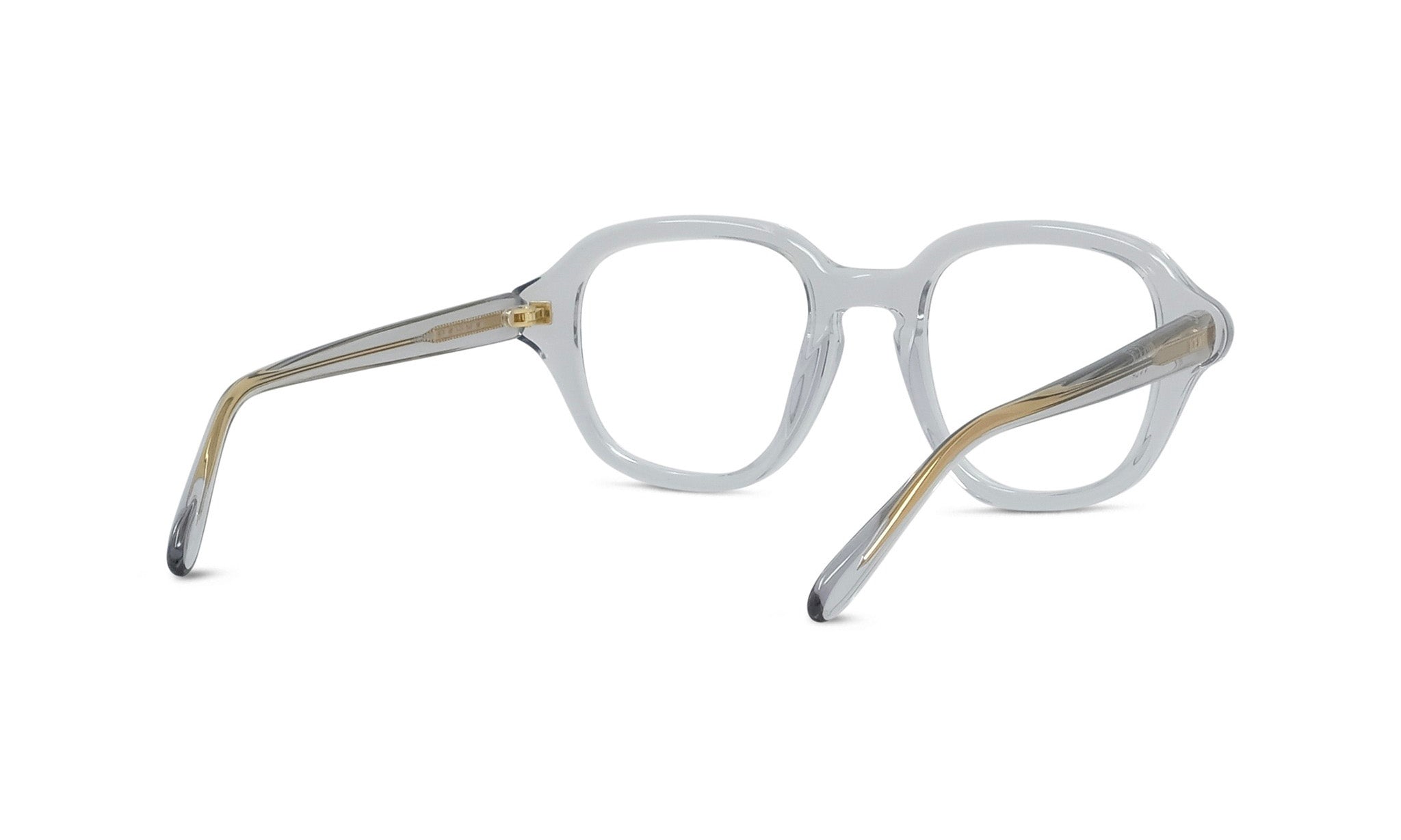 A pair of clear eyeglasses with gold-colored metal accents.
