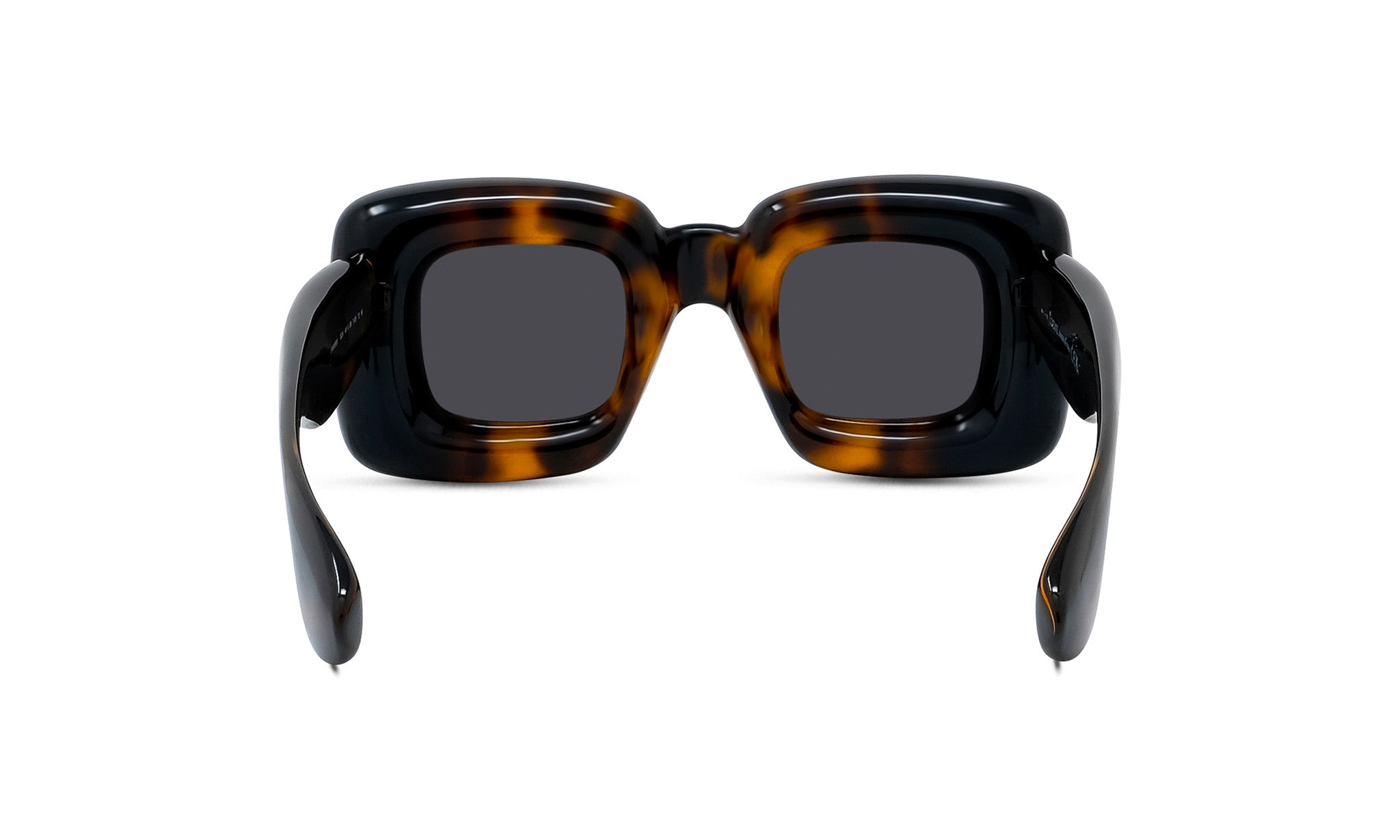 A pair of tortoiseshell sunglasses with dark frames and dark lenses.