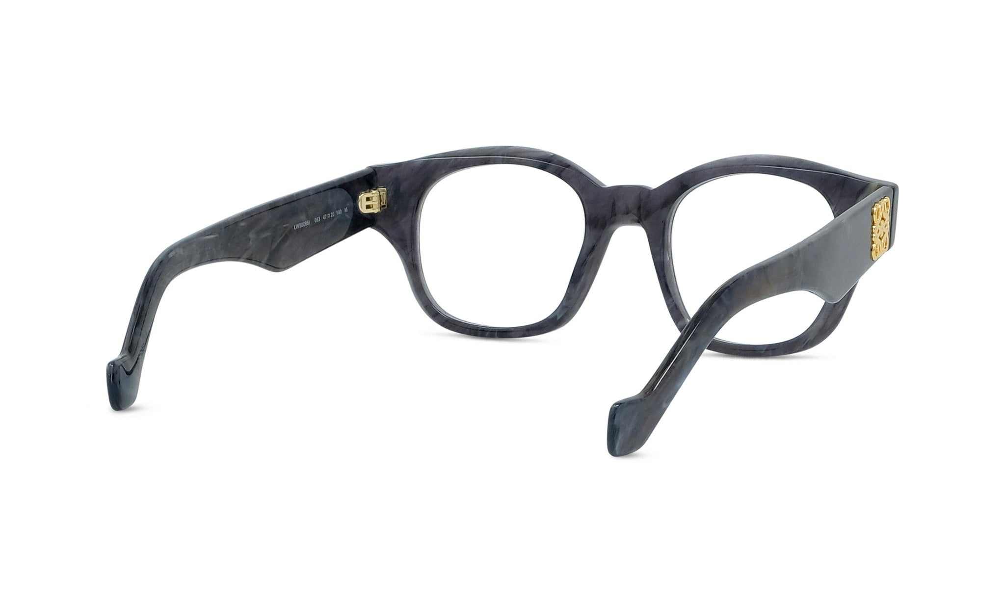 A pair of dark-colored, framed glasses with a gold-colored accent on the temples.