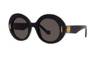 A pair of black round sunglasses with gold accents.