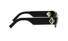 A pair of black sunglasses with a gold logo on the frame.