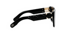 A pair of black sunglasses with gold accents, featuring a diamond pattern on the frame.