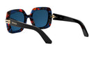 A pair of stylish sunglasses with a blue frame and a black frame, featuring a floral pattern.