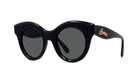 A pair of black cat-eye sunglasses with a gold logo on the frame.