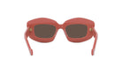 A pair of red-tinted sunglasses with dark lenses.