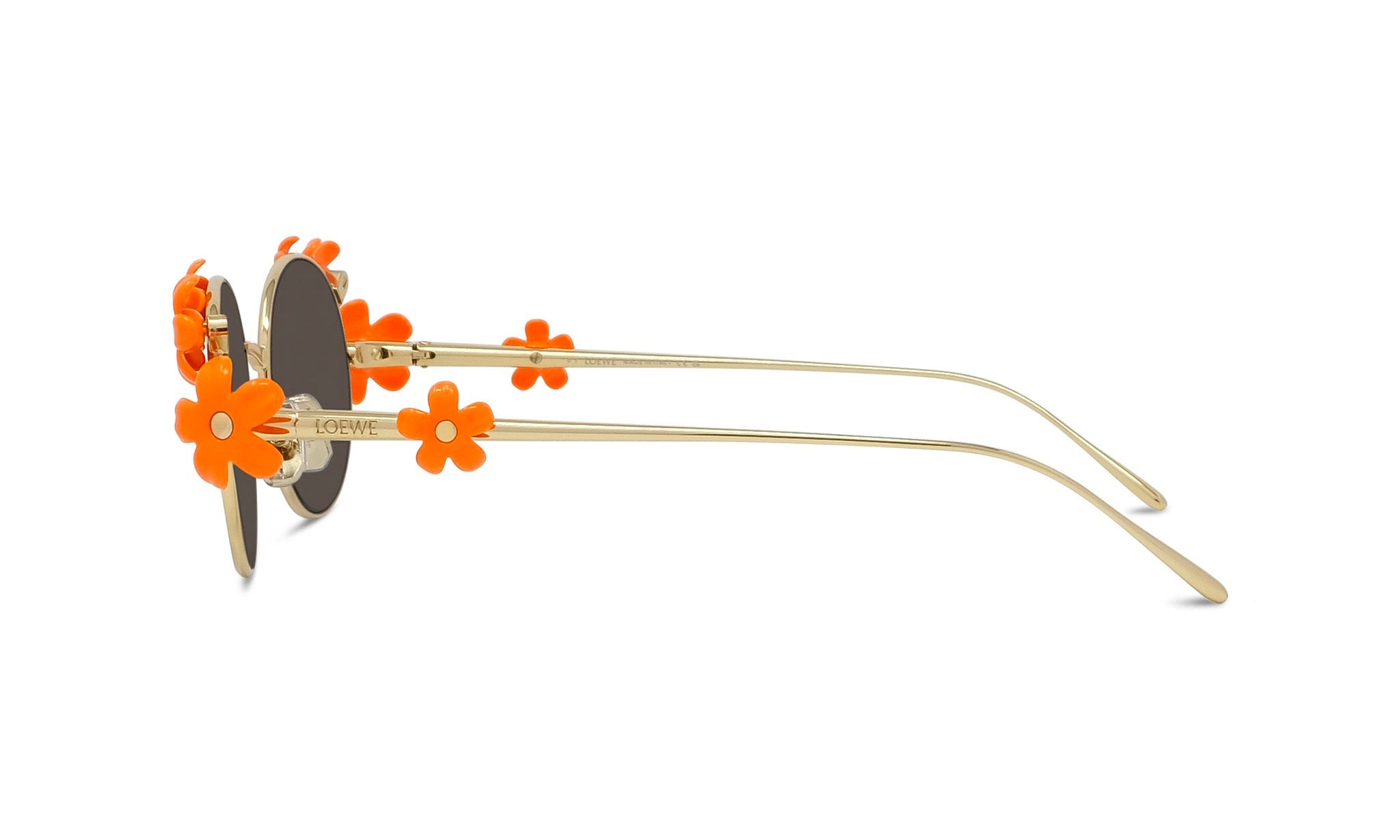 A pair of stylish sunglasses with orange flower embellishments on the temples and arms.