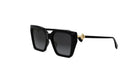 A pair of black sunglasses with a gold accent, featuring a square frame and dark lenses.