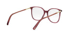 A pair of red-tinted glasses with gold-colored metal arms and temples.