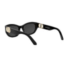 A pair of black sunglasses with gold accents, featuring the Dior logo on the frame.