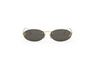 A pair of oval-shaped sunglasses with gold-colored frames and dark lenses.