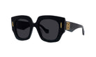 A pair of black sunglasses with gold accents, featuring a distinctive logo on the frame.