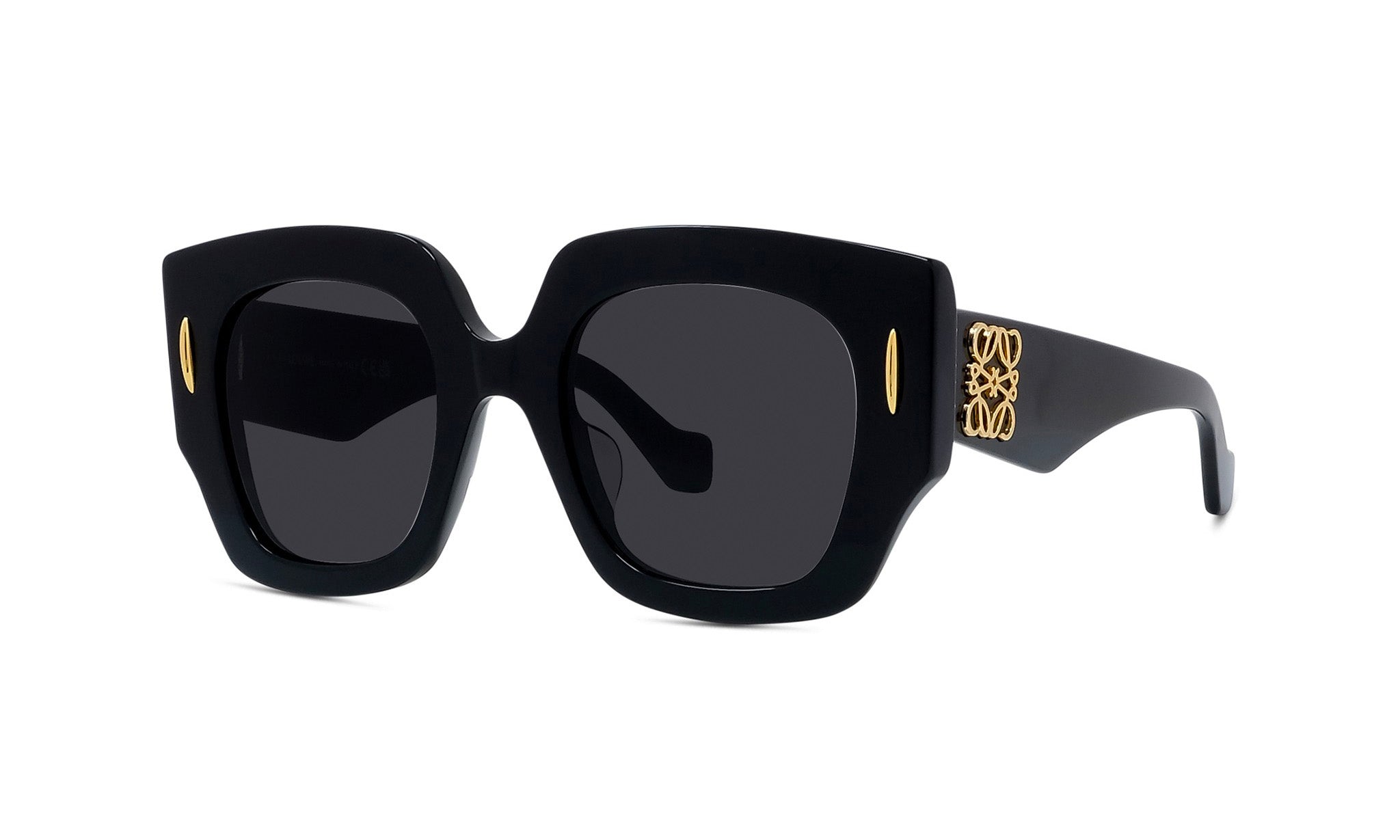 A pair of black sunglasses with gold accents, featuring a distinctive logo on the frame.