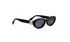 A pair of black sunglasses with a gold-colored frame and dark lenses.