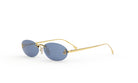 A pair of gold rimmed sunglasses with dark blue lenses.