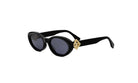 A pair of black sunglasses with a gold-colored frame and a gold-colored accent on the temples.