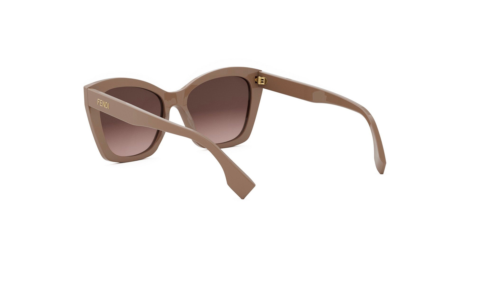 A pair of tan-colored sunglasses with a dark frame, featuring a gold-colored logo on the frame.