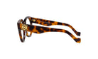 A pair of tortoiseshell-framed glasses with a gold-colored logo on the temples.