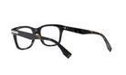 A pair of tortoiseshell-framed glasses with dark frames and a white lens.